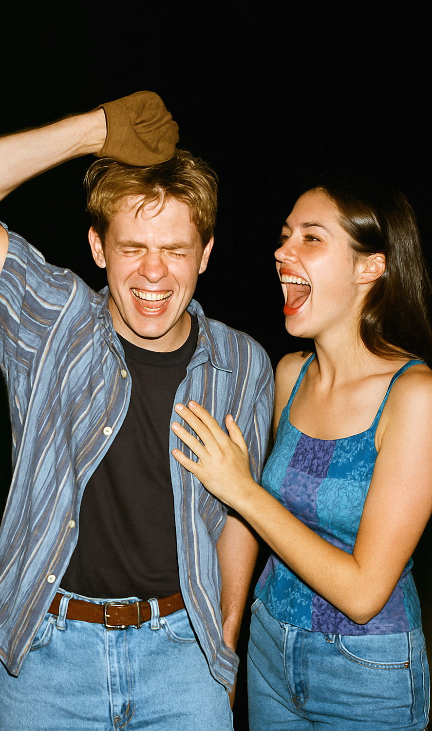 A person laughing with a puzzled expression, capturing the unique reaction absurdist humor often elicits when jokes defy conventional punchlines.