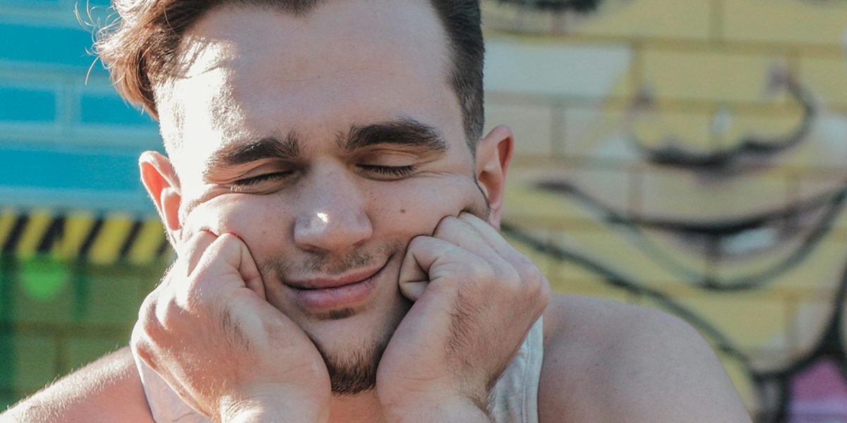 A person making a highly expressive or exaggerated facial expression, conveying emotion or humor.
