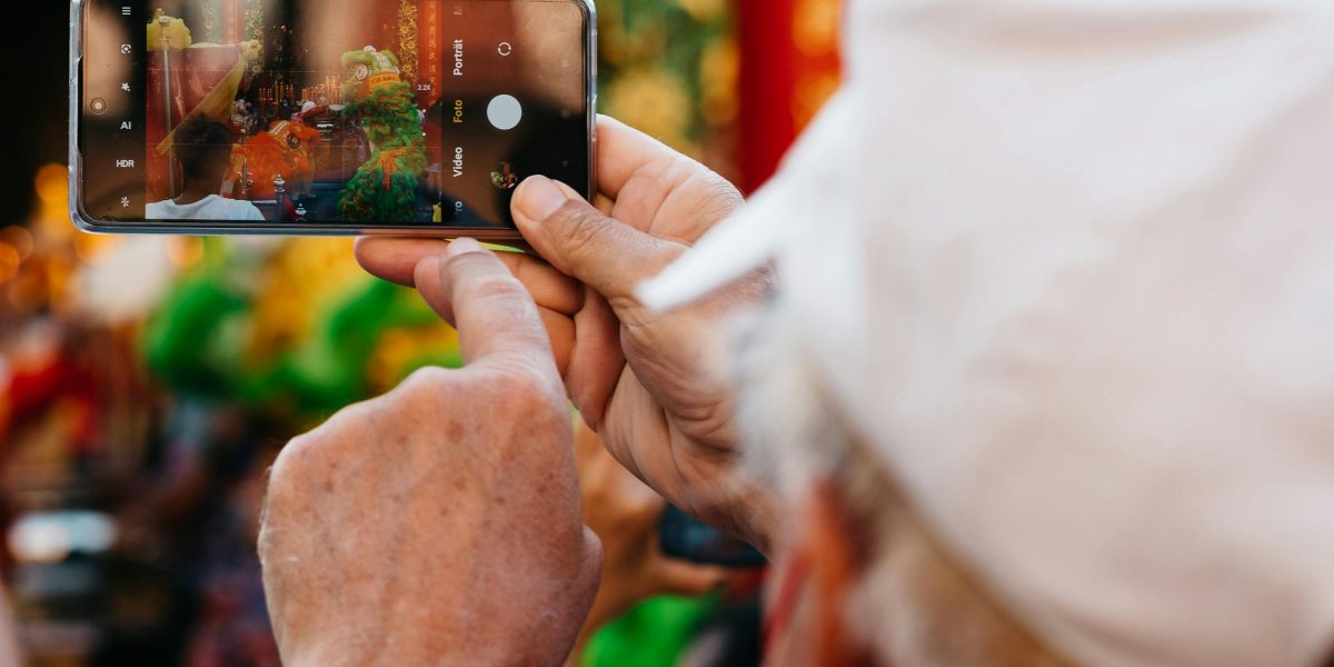 An individual engaging with digital content, likely sharing a funny meme or video, exemplifying emotional contagion.