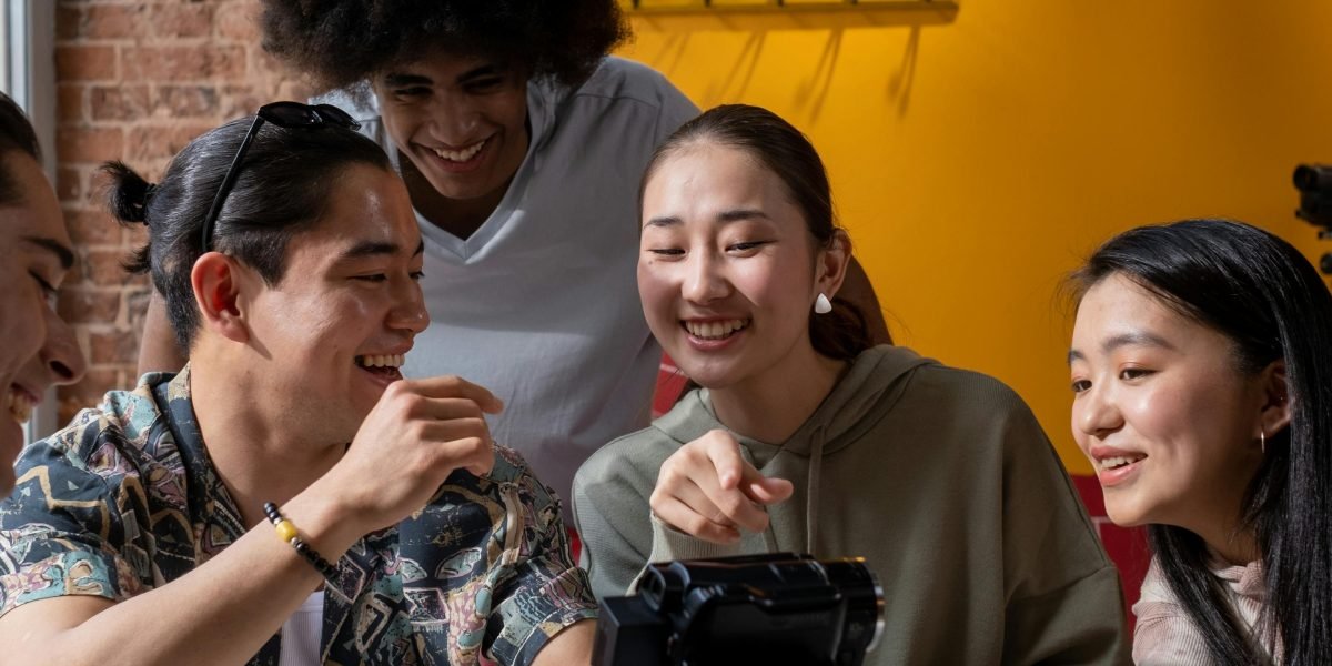 A group of friends sharing a moment of genuine laughter in a relaxed setting, like a coffee shop.